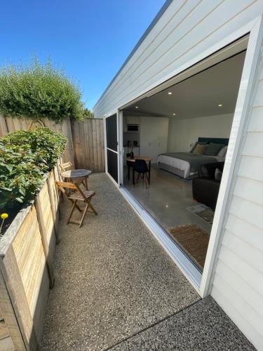 a room with a bed and a bedroom with a balcony at Port Fairy BNB - The Green Suite in Port Fairy