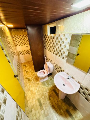 a bathroom with a toilet and a sink at Tishan Holiday Resort in Polonnaruwa