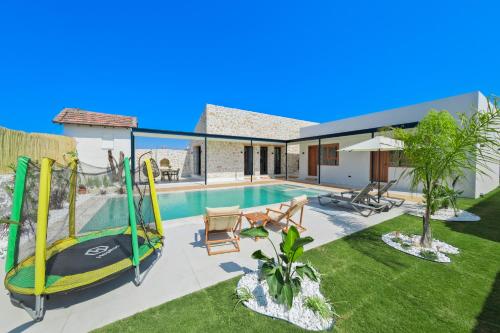 a villa with a swimming pool and a house at Inn Villas in Fethiye