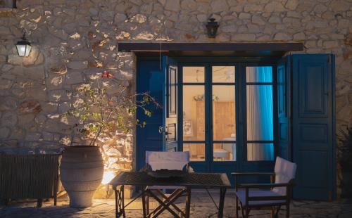 a blue door with a table and chairs and a vase at Casa Picimenti Zakynthos Marathias Swimming Pool Ground Floor Villa in Marathias