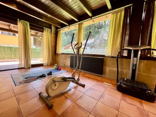 a room with a gym with exercise equipment on the floor at Secret Paradise, Stylish Host in Camargo