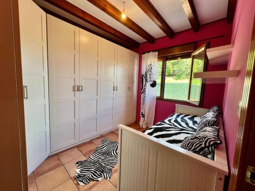 a zebra themed room with two zebras laying on the floor at Secret Paradise, Stylish Host in Camargo