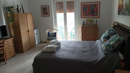 a bedroom with a bed and a tv and a chair at Roma Casetta - Tourist Rooms in Guidonia