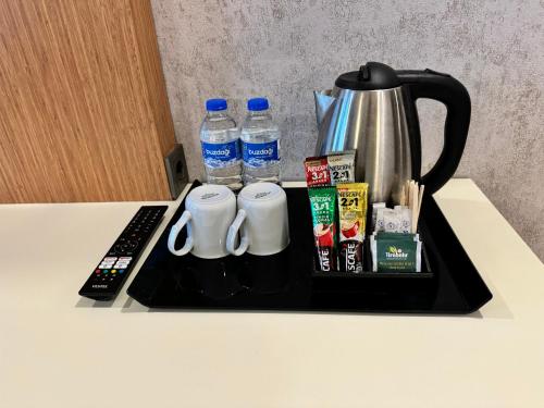 a tray with a coffee pot and two bottles of water at E5 PARK OTEL in Esenyurt