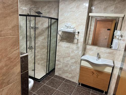a bathroom with a shower and a sink at E5 PARK OTEL in Esenyurt