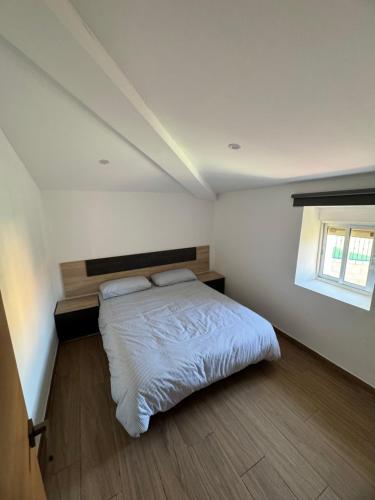a bedroom with a bed and a window at Casa La Molina in Burgos