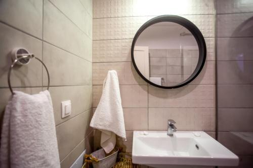 a bathroom with a sink and a mirror at Ionian Kaizer Boutique in Achílleion