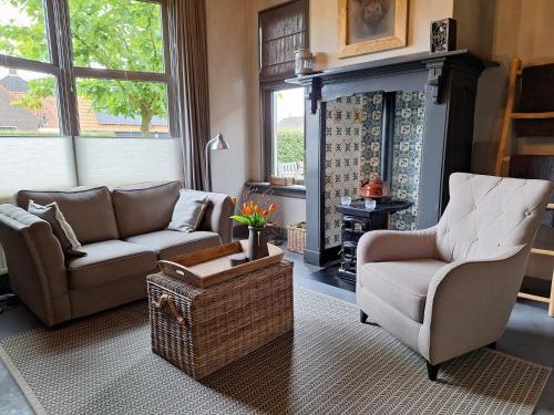 a living room with a couch and a chair at B&B De Meidoornhof in Ruinen