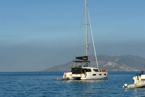 a white sailboat floating in the water at Verdelis Inn in Ancient Epidavros