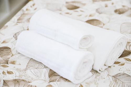 two white towels sitting on top of a bed at Urban loft in Forio d'Ischia