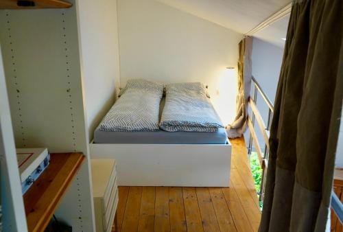 a small bedroom with a bed in a room at Privates & ruhiges Maisonette - Loft in Pulheim in Pulheim