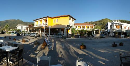 a town with a street with tables and buildings at Verdelis Inn in Ancient Epidavros