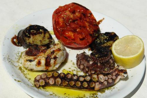 a plate of food with oysters and a lemon at Verdelis Inn in Ancient Epidavros