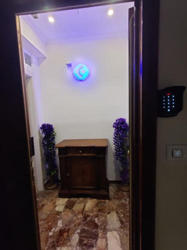 a room with a door with a clock on the wall at Robert's Sweet Station House A in Anguillara Sabazia