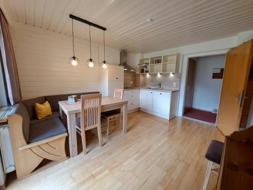 a kitchen and dining room with a table and a couch at Haus Kaunergrat in Kaunertal