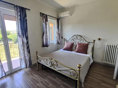a bedroom with a metal bed with pillows on it at Robert's Sweet Station House A in Anguillara Sabazia