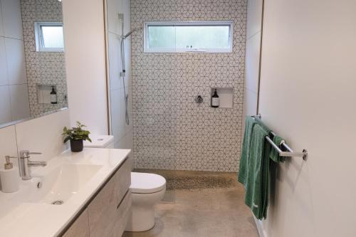 a bathroom with a toilet and a sink and a window at Port Fairy BNB - The Green Suite in Port Fairy