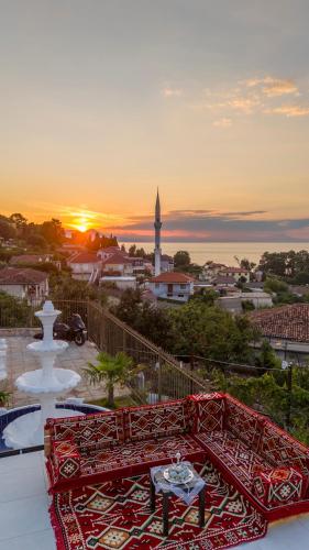 a view of a sunset from a balcony with a table at Vila Sela in Shkodër
