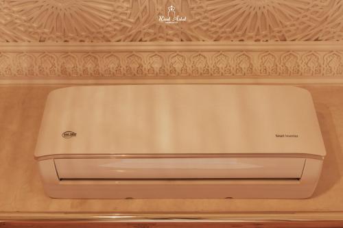 a white refrigerator freezer sitting on top of a wall at Riad Aslal in Marrakech