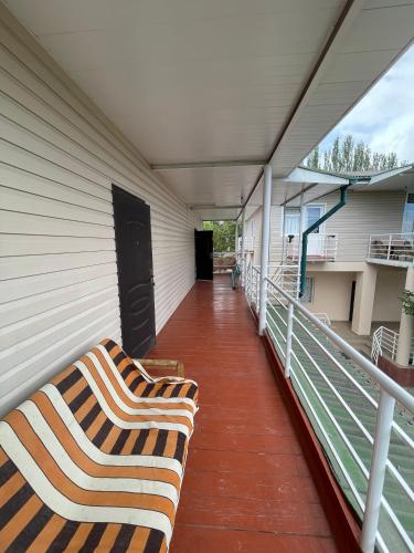 a balcony with two couches on a house at Отель на берегу in Bosteri