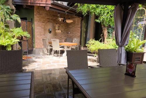 an outdoor patio with a wooden table and chairs at Willa Pirs in Warsaw
