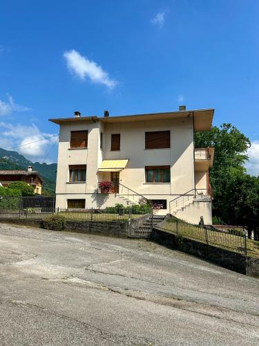 a white building on the side of a street at La Casa dei Nonni in Alano di Piave