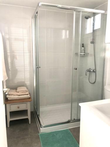 a shower with a glass door in a bathroom at White House studio with sea view and parking in Polis Chrysochous