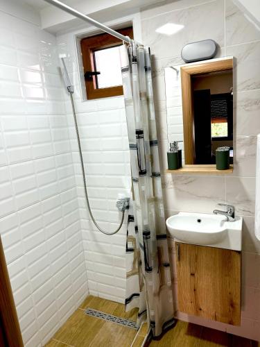 a bathroom with a sink and a shower at Modern in center in Žabljak
