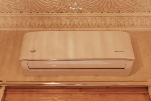a white dishwasher sitting in a drawer in a kitchen at Riad Aslal in Marrakech