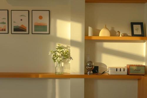 a shelf with a vase with a plant on it at SaroRach pool villa resort Kohlarn in Ko Larn