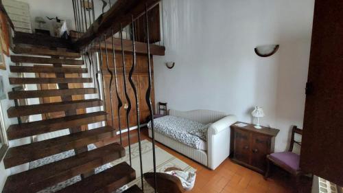 a living room with a staircase and a chair at Il Casale Del Sogno in Ardea