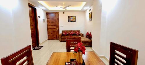 a living room with a table and a couch at Yogvan Luxury 1BHK Apartments Tapovan Rishikesh in Rishīkesh