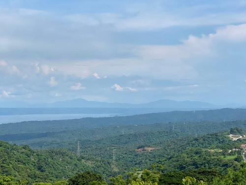 a view of the ocean from a hill with trees at Splendido Tagaytay Taal Lake Staycation Free Parking Netflix No Free Pool in Tagaytay