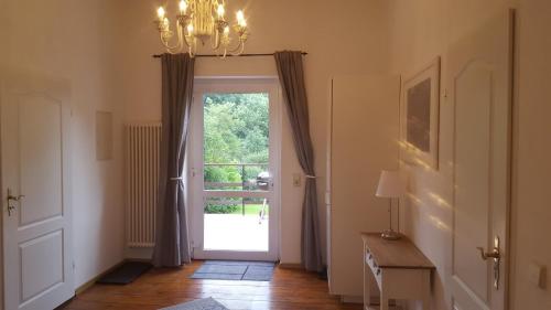 a hallway with a door leading to a patio at Business Apartments Netzeband in Netzeband