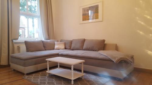 a living room with a couch and a table at Business Apartments Netzeband in Netzeband