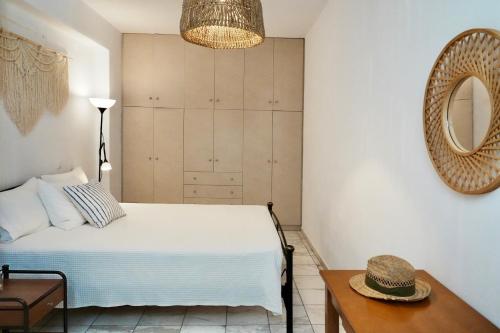 a bedroom with a bed and a mirror and a table at Dimora Miranda in Agios Prokopios