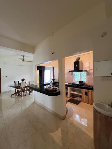 a kitchen with a table and a dining room at Camilla Living- A Luxury Escape by the Riverside! in Guwahati
