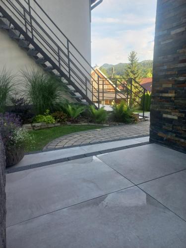 a walkway leading to a patio with a stair case at GOLD apartamenty & spa in Szczawnica