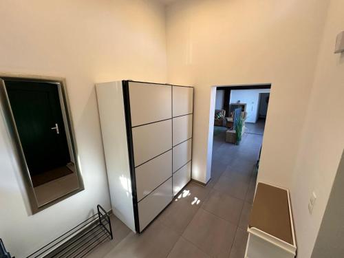 a room with a large glass cabinet and a hallway at Ferienwohnung Ottenhof in Verden