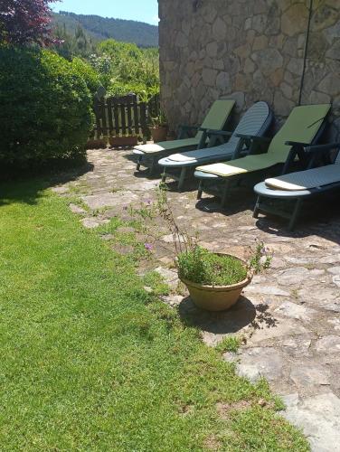 a group of benches sitting on a stone patio at Naturaleza, Confort y Magnificas vistas a Sierra de Gata TR-CC-00490 in Gata