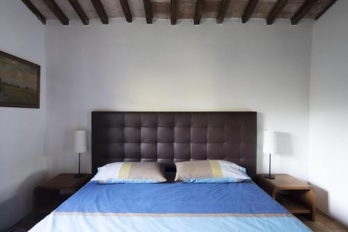 a bedroom with a large bed and two night stands at Sant'Anselmo in Bagnoregio
