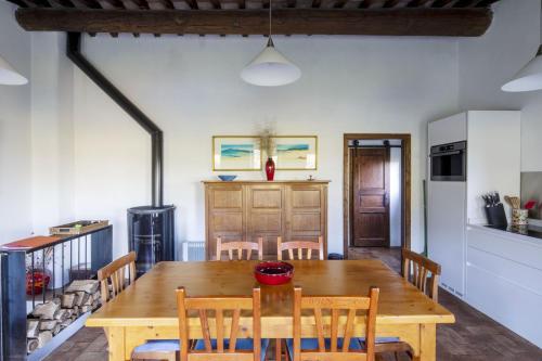 a kitchen and dining room with a wooden table and chairs at Sant'Anselmo in Bagnoregio
