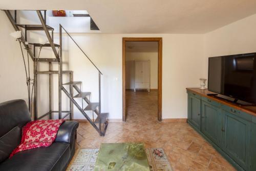 a living room with a couch and a flat screen tv at Sant'Anselmo in Bagnoregio