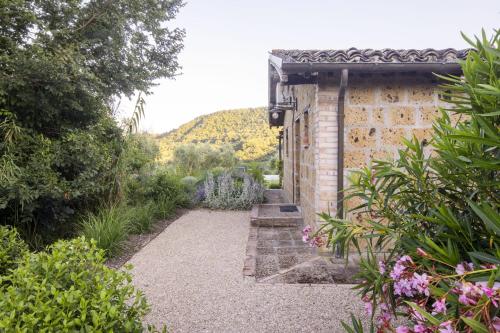 a garden with a brick building and some plants at Sant'Anselmo in Bagnoregio