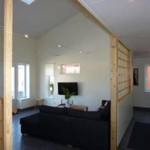a living room with a couch and a tv at Høystandard feriehytte, Utendørs boblebad, sauna in Filipstad