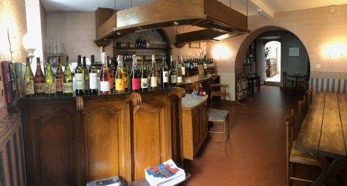 a bar with a bunch of bottles of wine at Hôtel Les Templiers in Luz-Saint-Sauveur