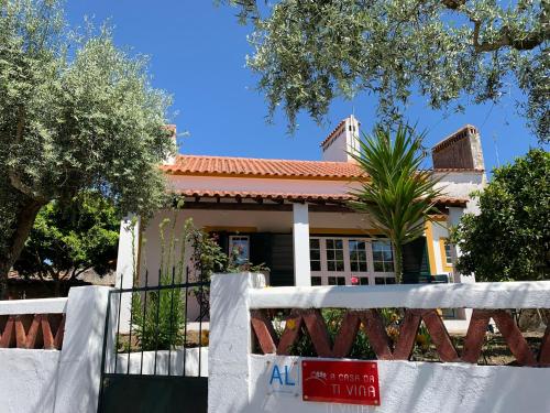 a house with a fence in front of it at A Casa da Ti Vina in Gavião