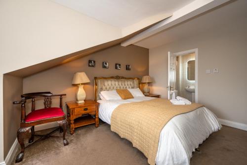 a bedroom with a large bed and a chair at Coach Hill House in Cork