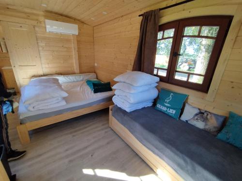 Saint-Lumine-de-Coutaisroulotte tout confort à la ferme 2的小木屋内一间卧室,配有两张床