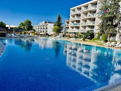 a large swimming pool in front of a hotel at Atlantis Resort & 4 swimming pools & Spa & Апартамент in Burgas City